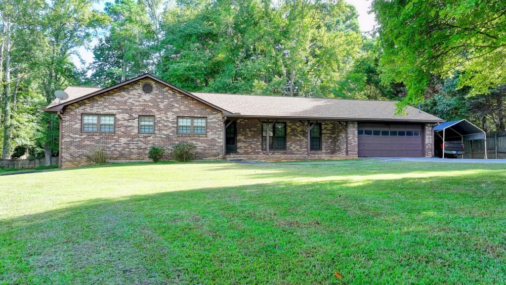 5680 Abbotts Bridge Road Johns Creek, GA 30097 - Photo 9 of 63 a front view of a house with a garden