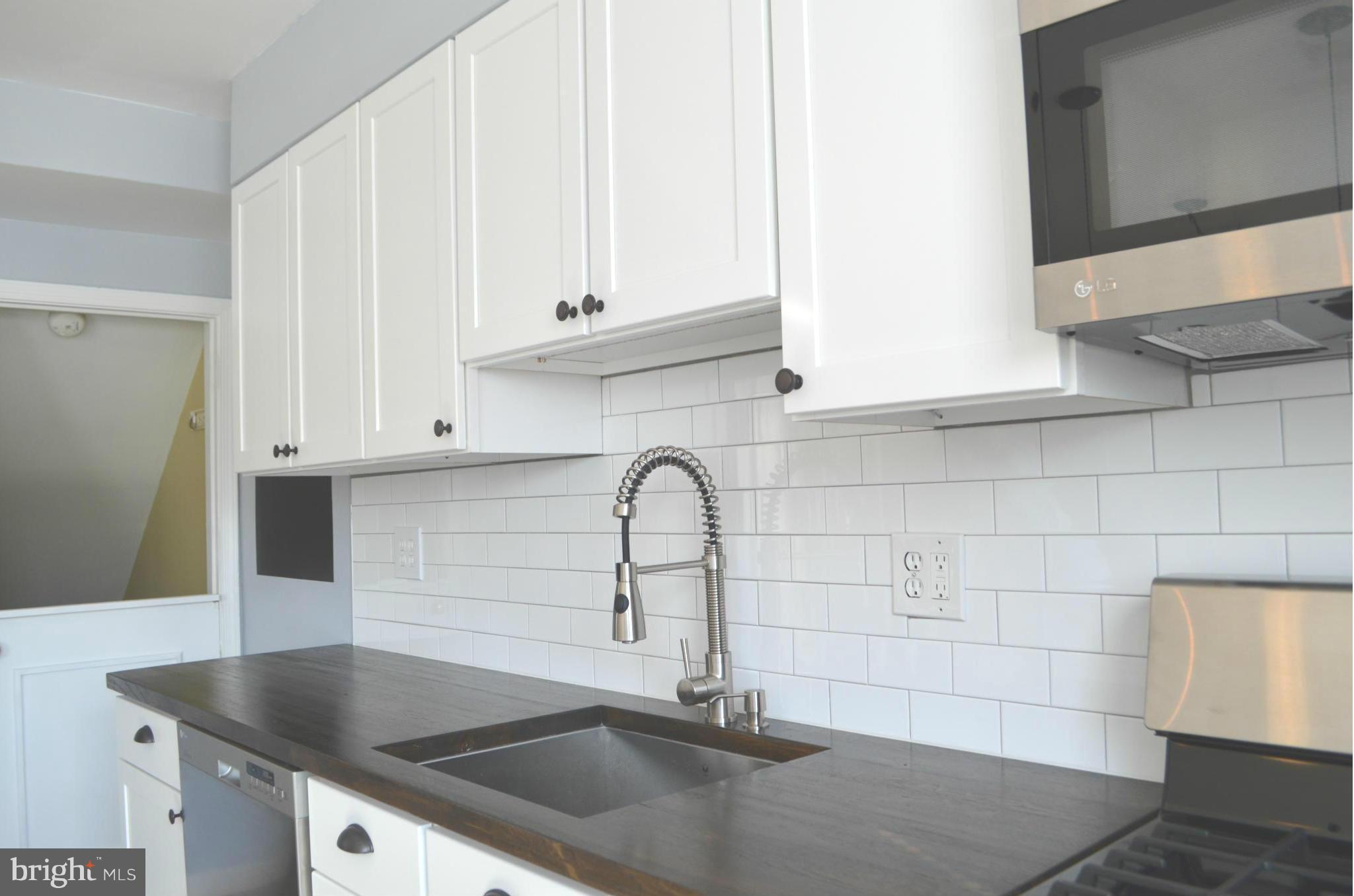 6109 Mt Ridge Road Baltimore, MD 21228 - Photo 9 of 26 Subway tiled back splash, under cabinet lighting!