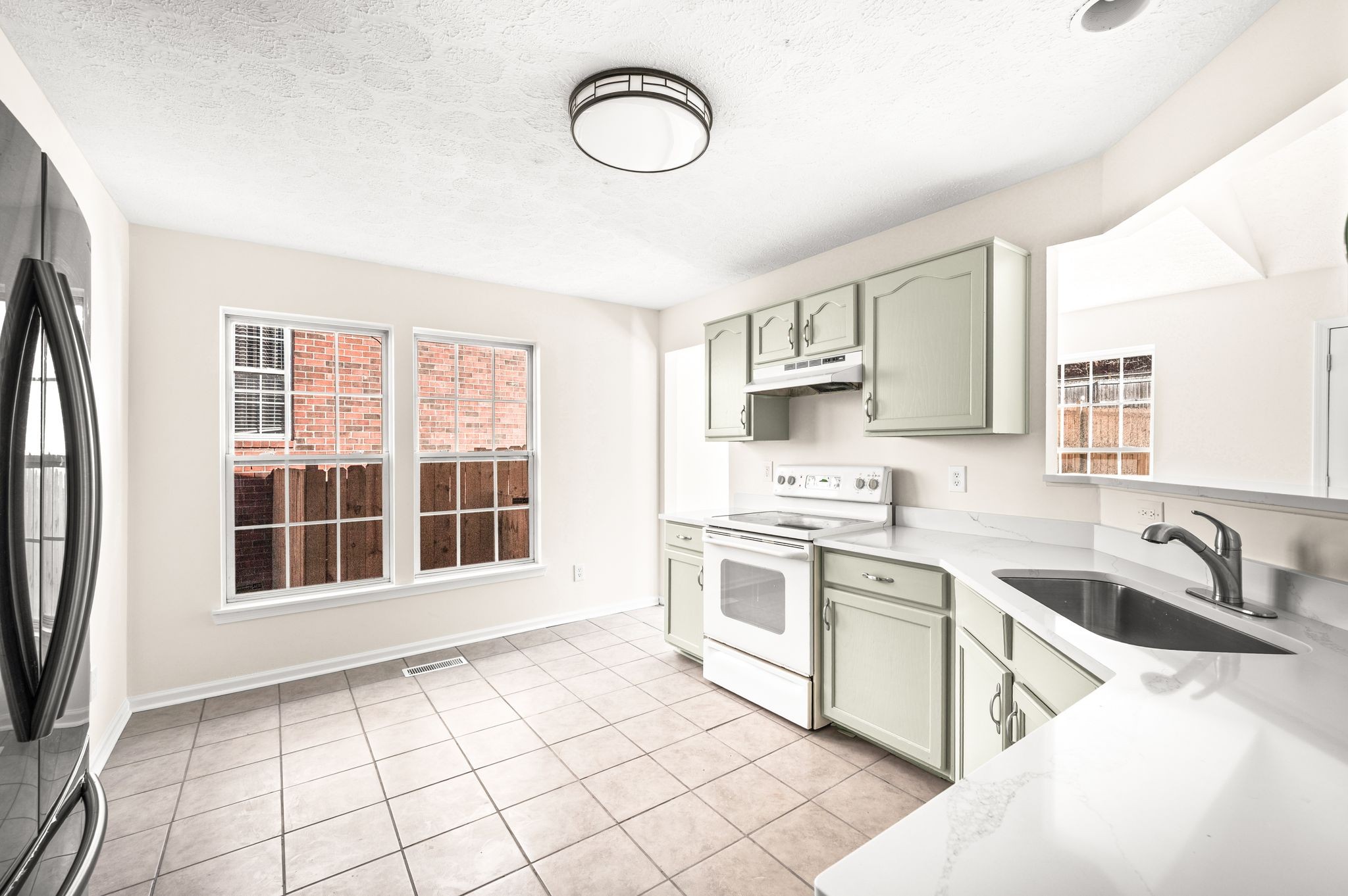 1304 West Running Brook Road Nashville, TN 37209 - Photo 14 of 28 a kitchen with stainless steel appliances granite countertop a stove and a sink
