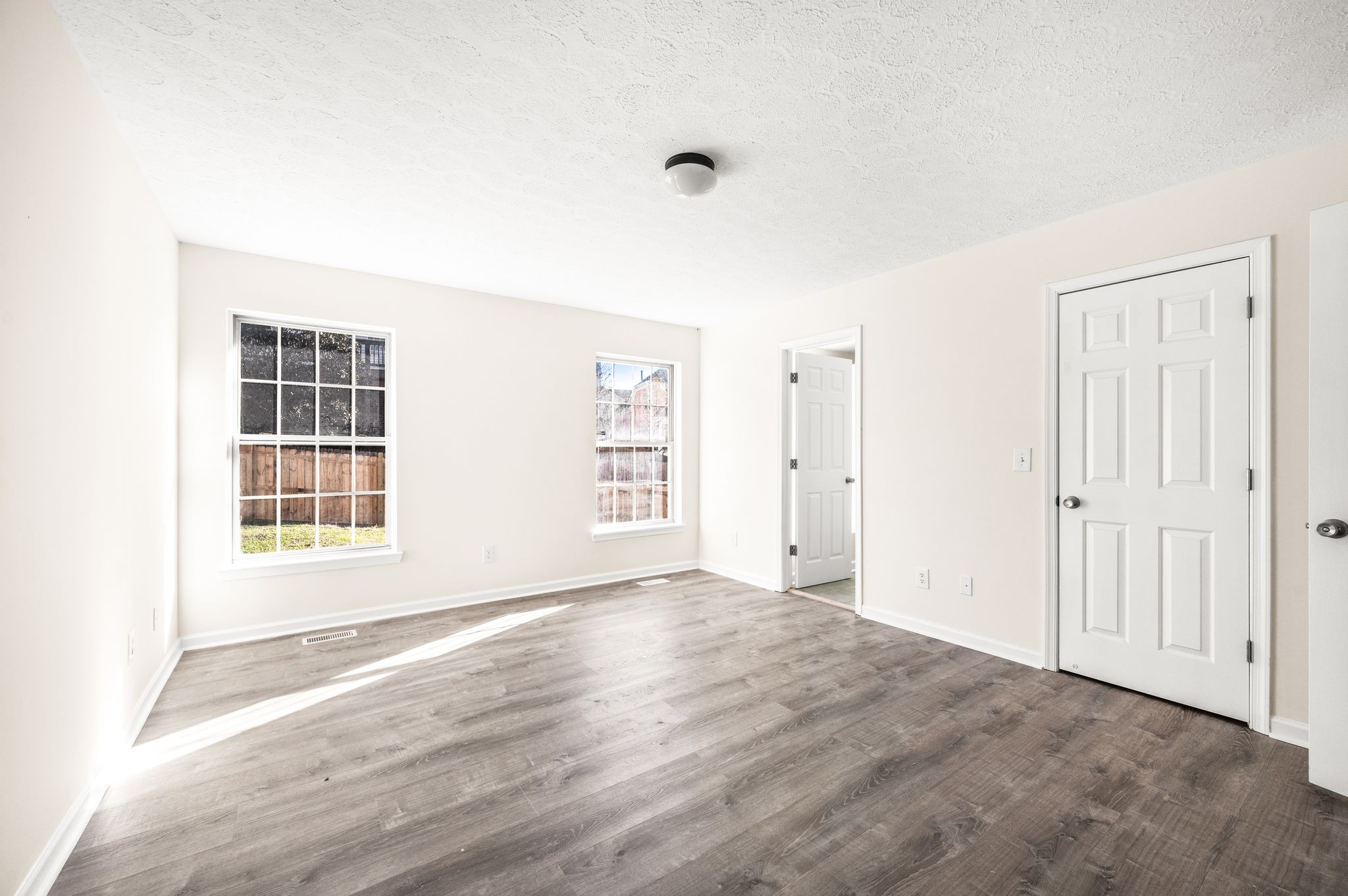 1304 West Running Brook Road Nashville, TN 37209 - Photo 16 of 28 a view of an empty room with wooden floor and a window
