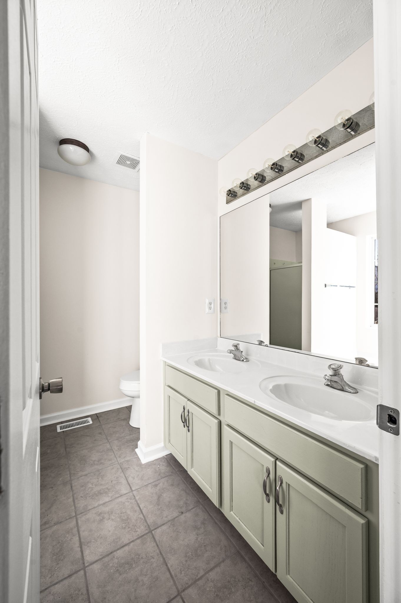 1304 West Running Brook Road Nashville, TN 37209 - Photo 18 of 28 a bathroom with a granite countertop sink a mirror and a bathtub