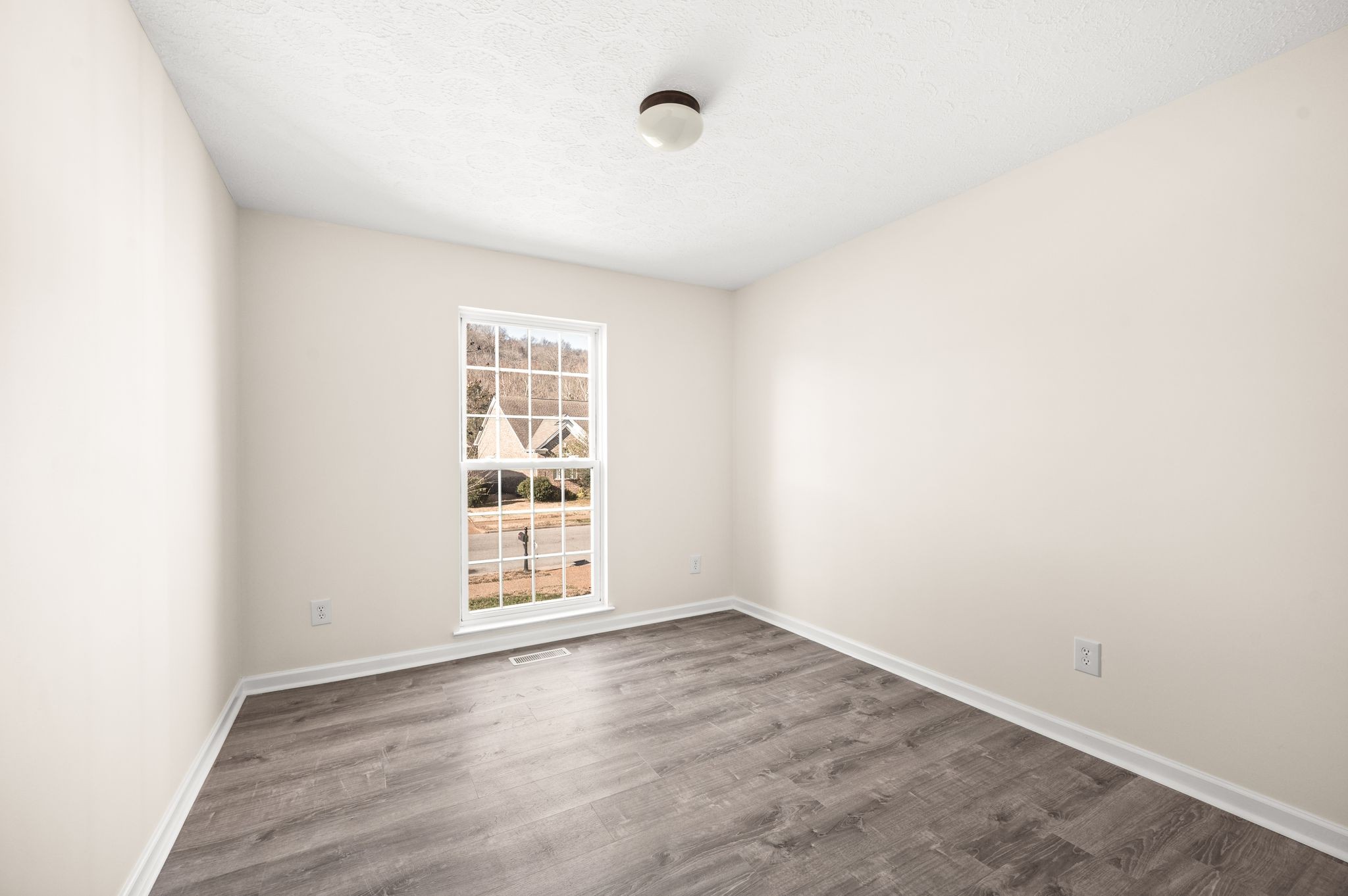 1304 West Running Brook Road Nashville, TN 37209 - Photo 22 of 28 an empty room with wooden floor and windows