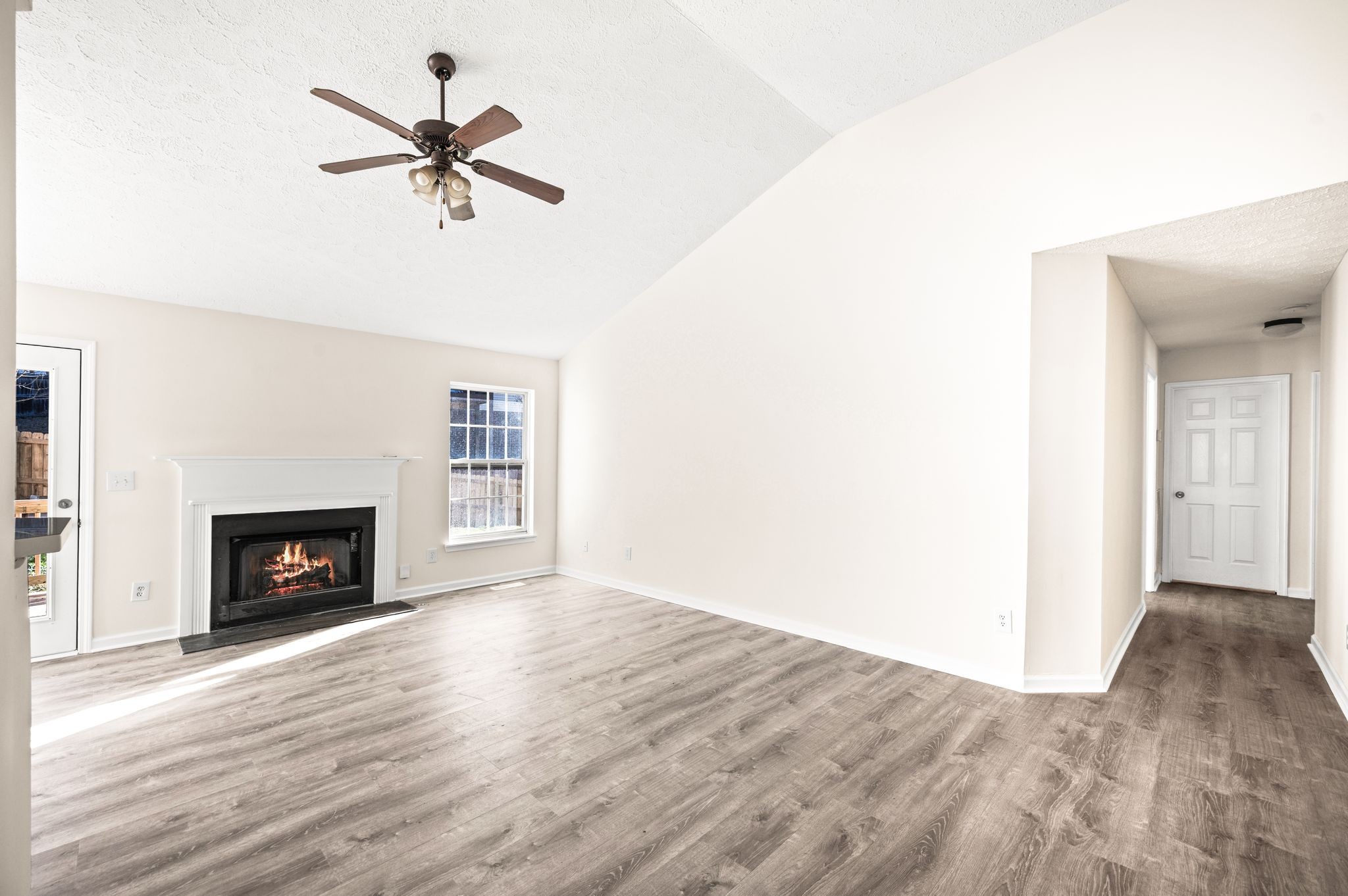 1304 West Running Brook Road Nashville, TN 37209 - Photo 7 of 28 a view of a livingroom with a fireplace a ceiling fan and wooden floor