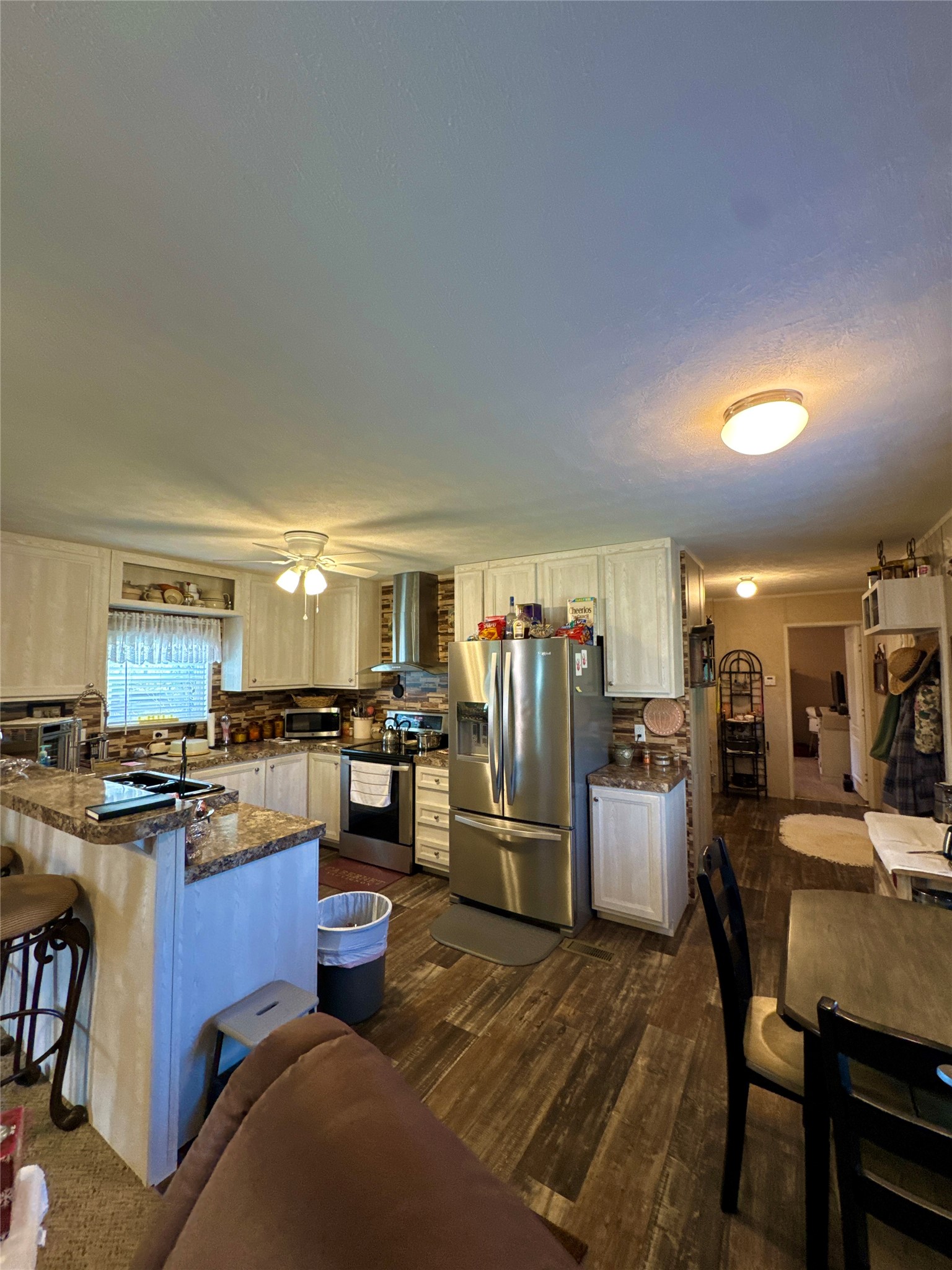 193 County Road 355 Jasper, TX 75951 - Photo 11 of 37 a kitchen with stainless steel appliances wooden floor and refrigerator