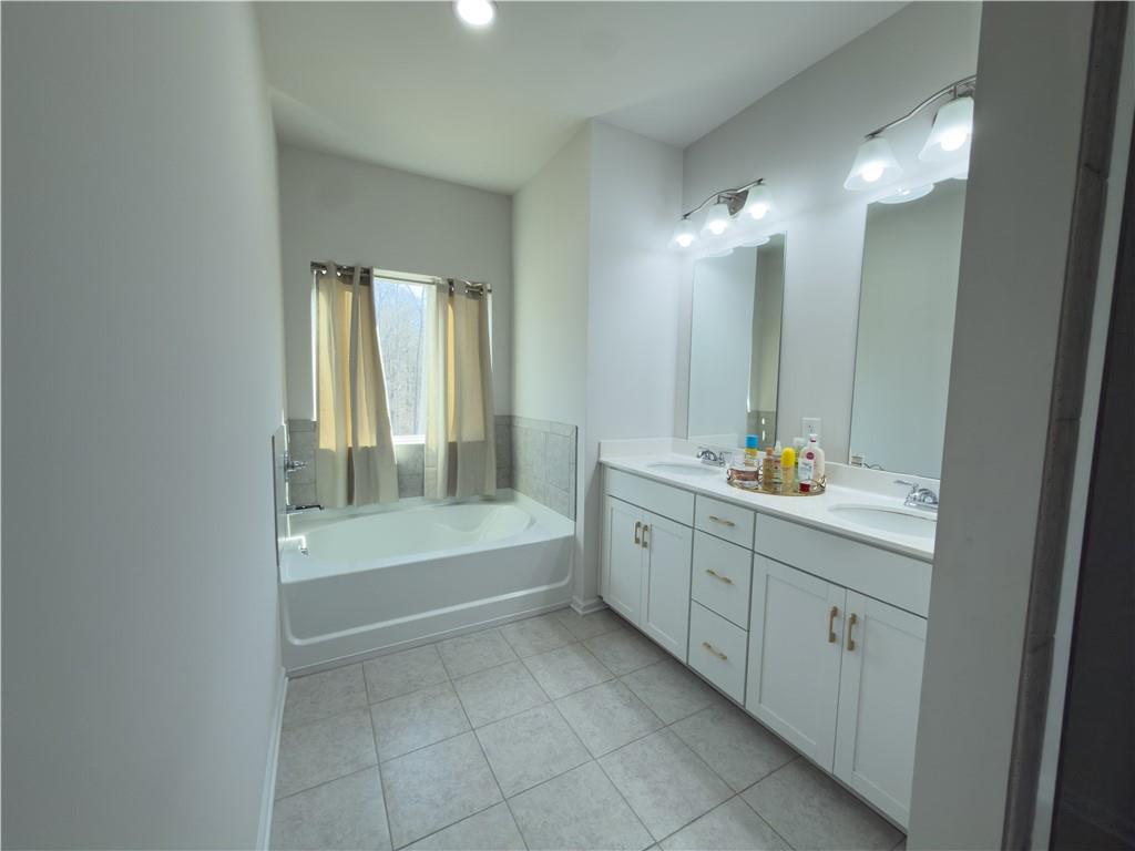 2115 Ravencliff Drive Austell, GA 30168 - Photo 13 of 21 a bathroom with a tub sink and mirror