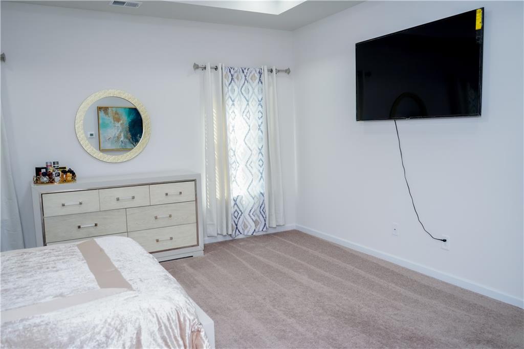 2115 Ravencliff Drive Austell, GA 30168 - Photo 15 of 21 a bedroom with a bed and a flat screen tv