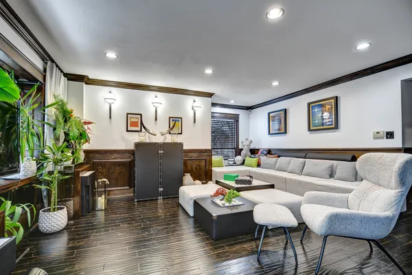 a living room with furniture and a potted plant