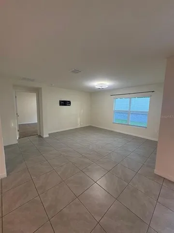 an empty room with a empty space and windows