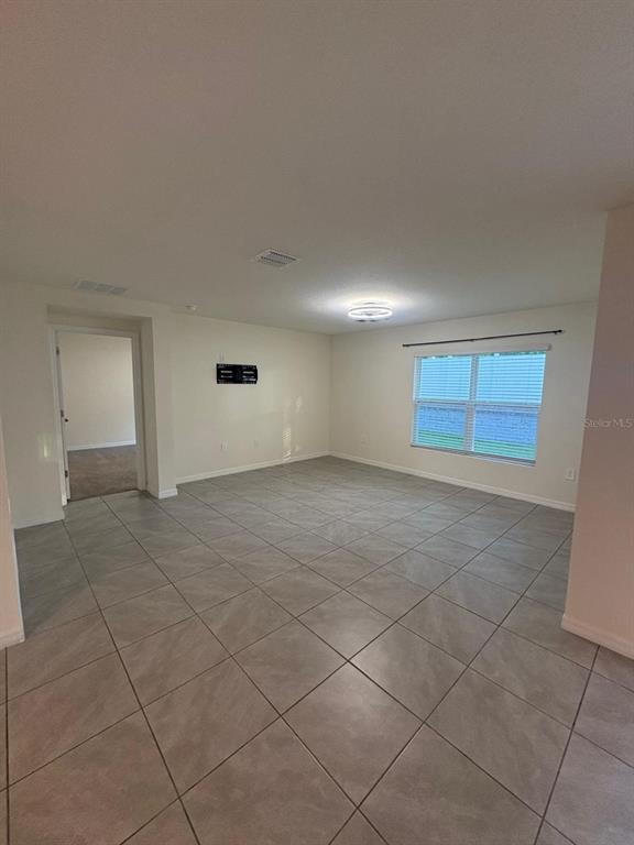 6910 Southeast 112th Street Belleview, FL 34420 - Photo 14 of 20 an empty room with a empty space and windows