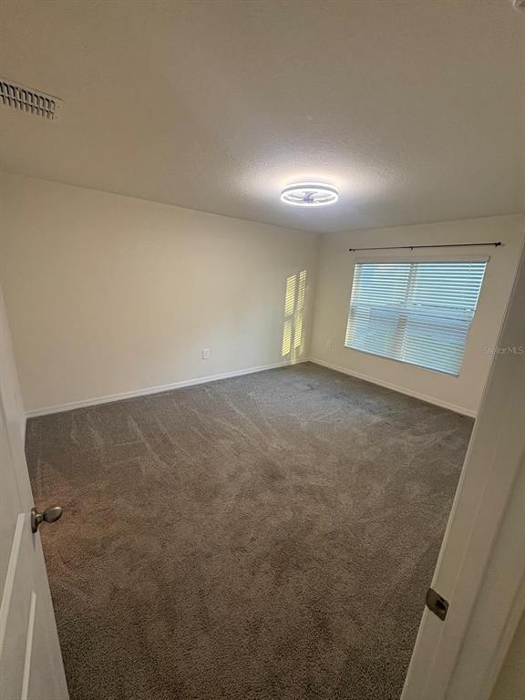 6910 Southeast 112th Street Belleview, FL 34420 - Photo 15 of 20 an empty room with windows