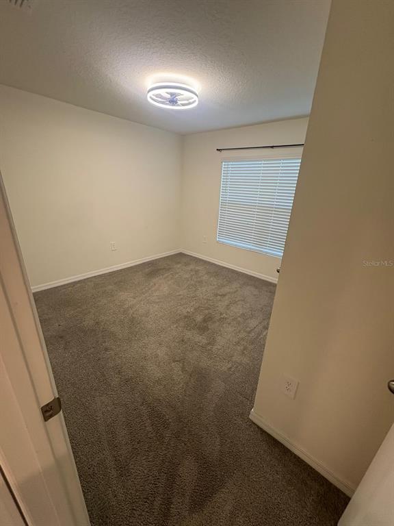6910 Southeast 112th Street Belleview, FL 34420 - Photo 3 of 20 an empty room with a workbench