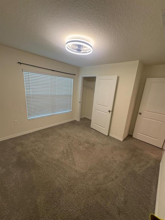 6910 Southeast 112th Street Belleview, FL 34420 - Photo 4 of 20 an empty room with a empty space and windows