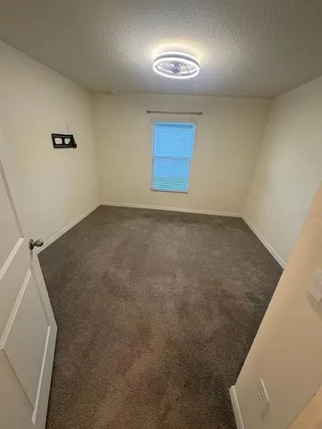 an empty room with a empty space and windows