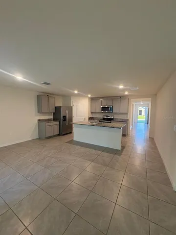 a large kitchen with cabinets and a stainless steel appliances
