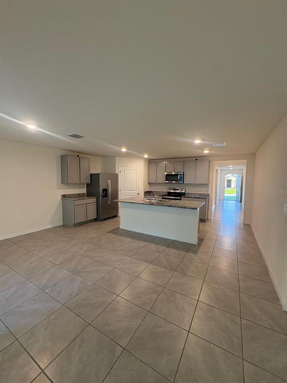 6910 Southeast 112th Street Belleview, FL 34420 - Photo 10 of 20 a large kitchen with cabinets and a stainless steel appliances