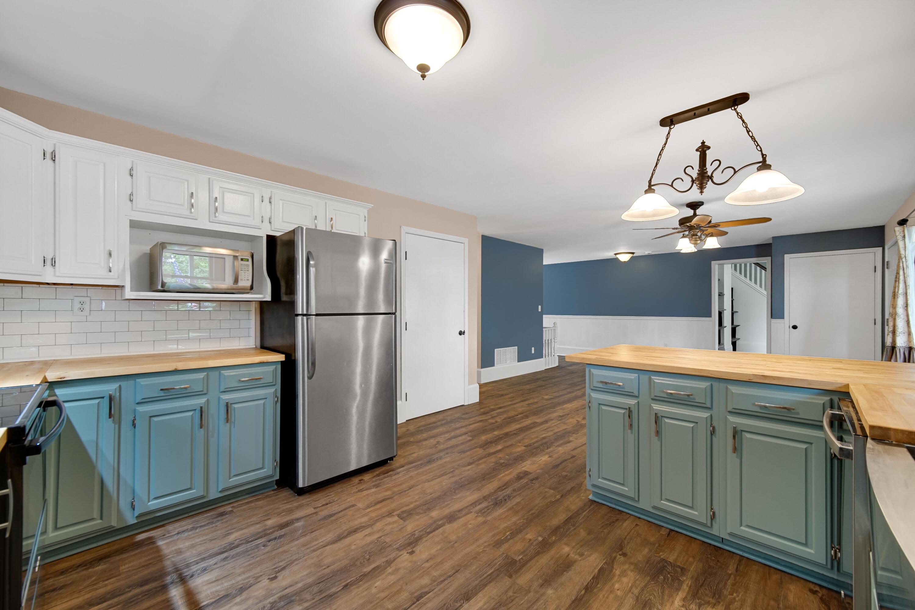 476 Highway 2 Hebron, IN 46341 - Photo 7 of 25 a kitchen with stainless steel appliances granite countertop a sink refrigerator and microwave