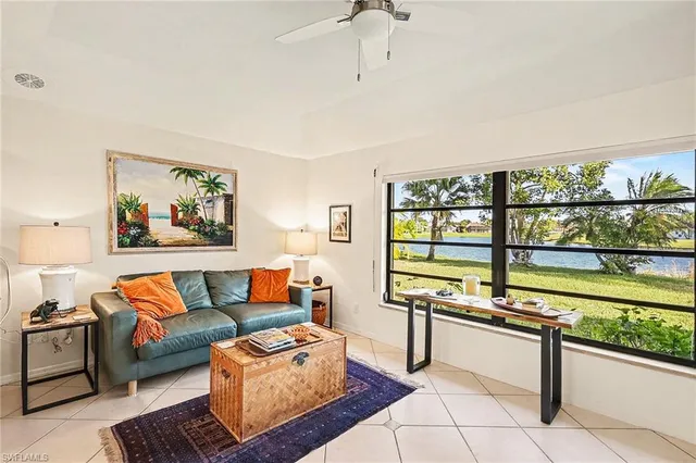 a living room with furniture and a floor to ceiling window