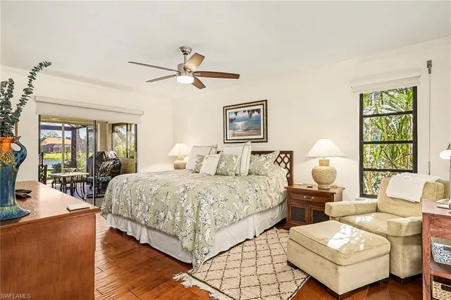 a spacious bedroom with a bed a couch and a window