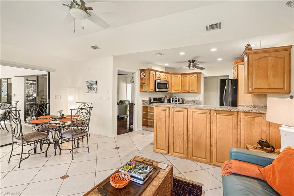 9874 Campbell Circle Naples, FL 34109 - Photo 6 of 27 a living room with furniture and kitchen view
