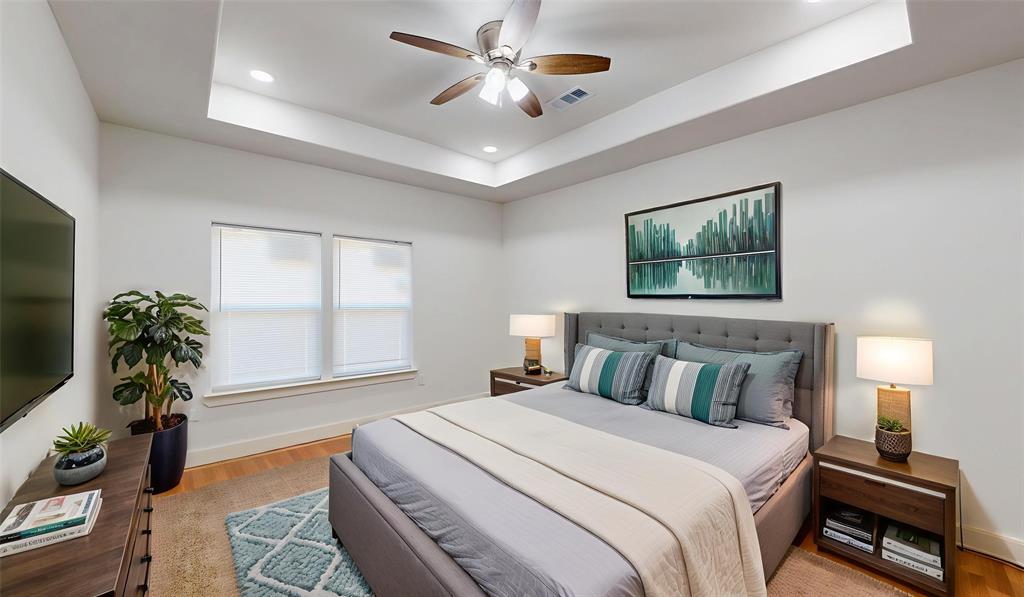 1615 Poplar Street Dallas, TX 75215 - Photo 13 of 31 a bedroom with a large bed and a chandelier
