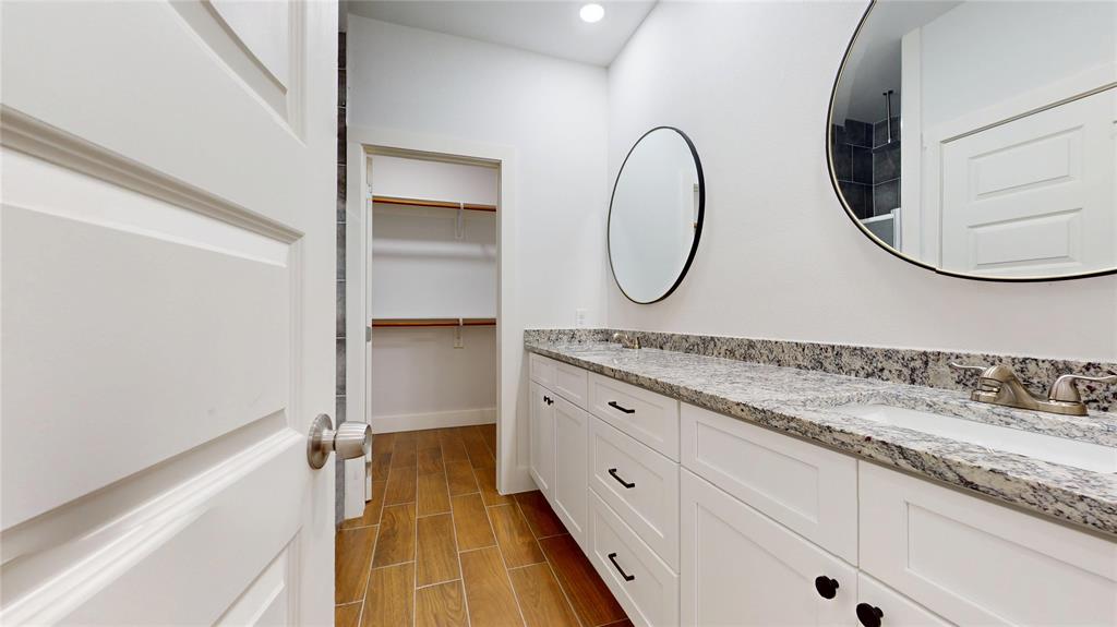1615 Poplar Street Dallas, TX 75215 - Photo 15 of 31 a bathroom with a granite countertop sink and a mirror