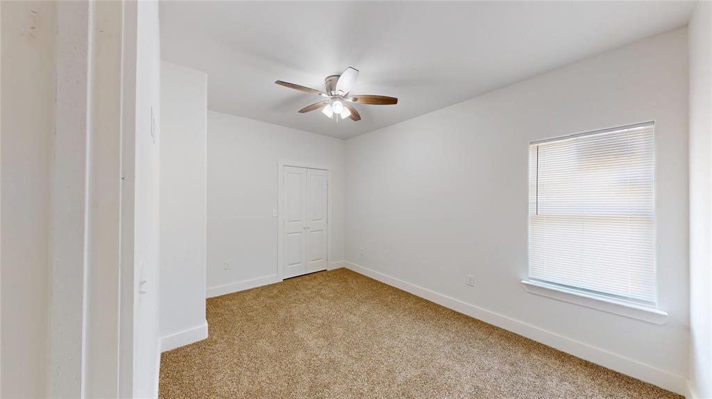 1615 Poplar Street Dallas, TX 75215 - Photo 22 of 31 an empty room with a window and a fan