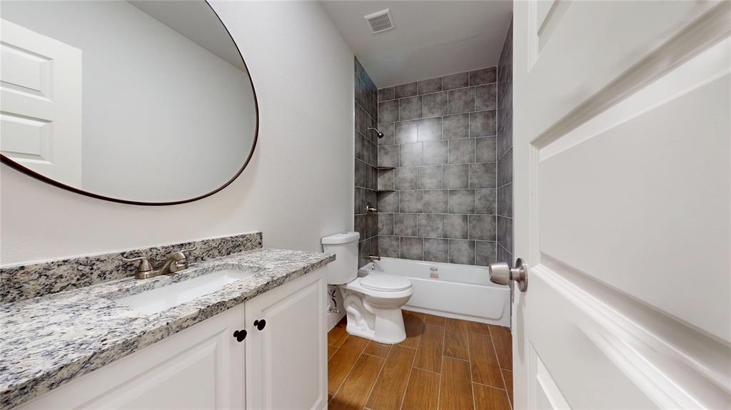 1615 Poplar Street Dallas, TX 75215 - Photo 25 of 31 a bathroom with a granite countertop sink mirror vanity and toilet