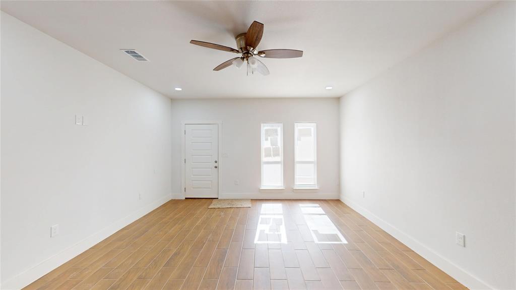 1615 Poplar Street Dallas, TX 75215 - Photo 3 of 31 an empty room with wooden floor fan and windows