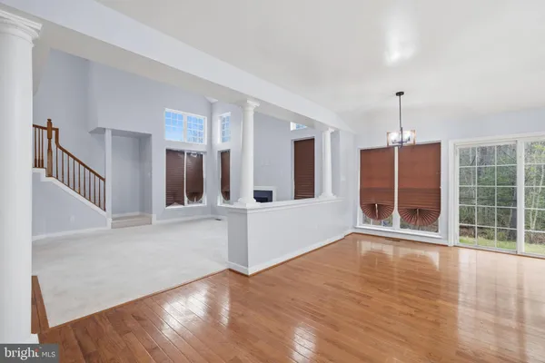a view of a room with wooden floor and windows