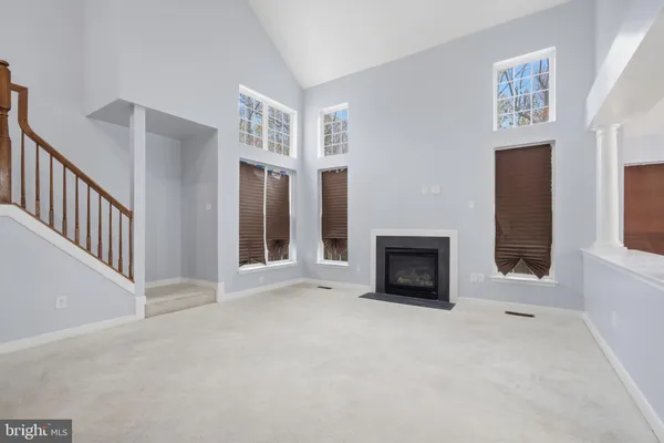 a view of a livingroom with a fireplace and window