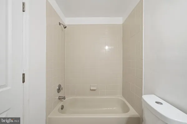 a bathroom with a bathtub and toilet