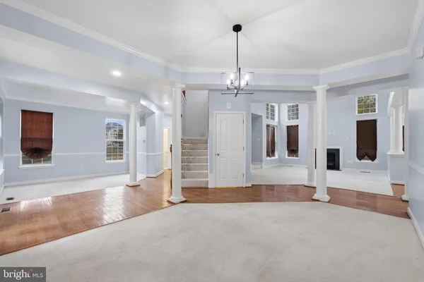 a view of a livingroom with wooden floor and chandelier