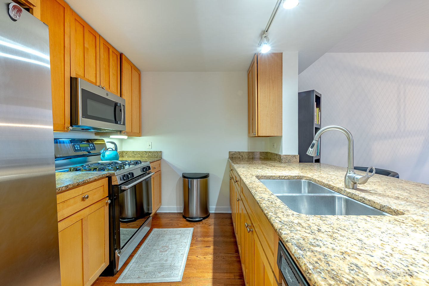 1151 West Washington Boulevard, Unit 125 Chicago, IL 60607 - Photo 5 of 24 a kitchen with a sink stove top oven and microwave