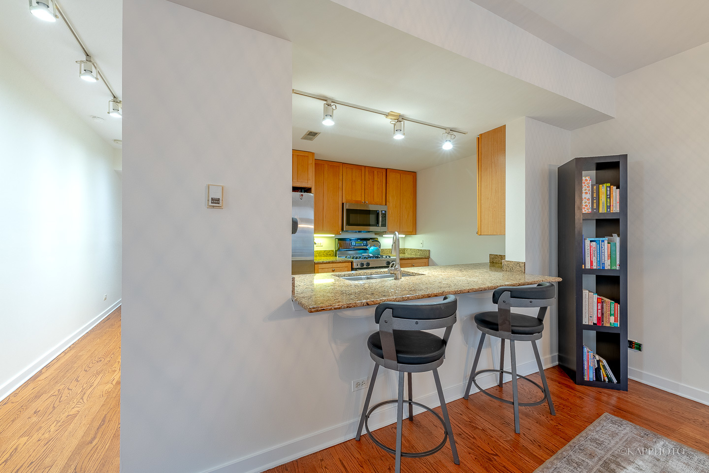 1151 West Washington Boulevard, Unit 125 Chicago, IL 60607 - Photo 8 of 24 a kitchen with stainless steel appliances granite countertop a sink and a refrigerator