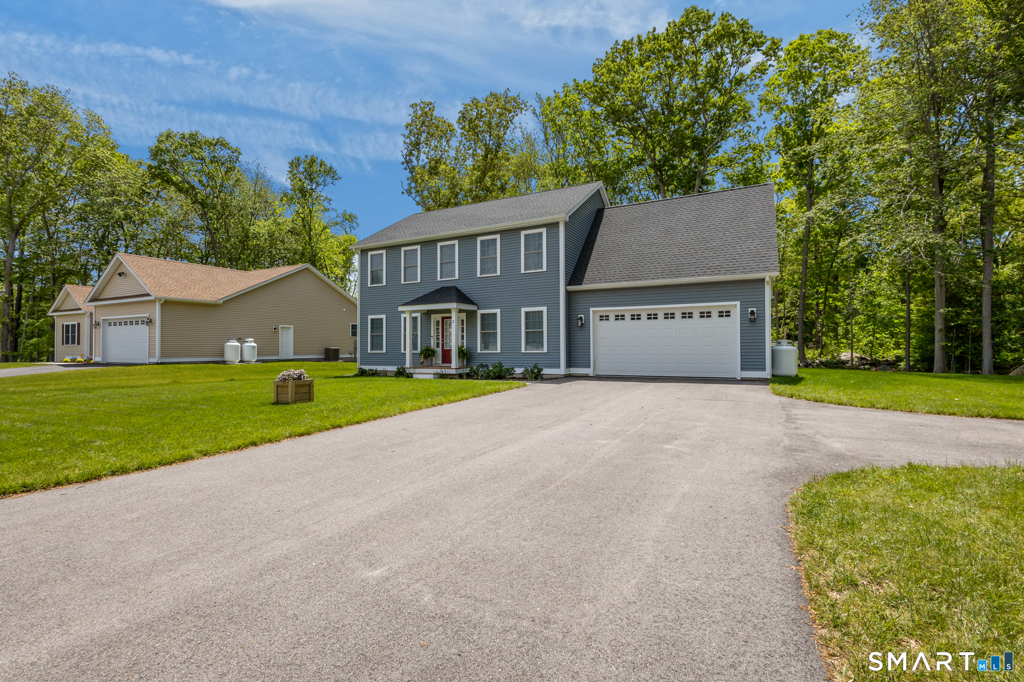 2 Martys Way Gales Ferry, CT 06335 - Photo 36 of 40 a front view of a house with a yard and garage