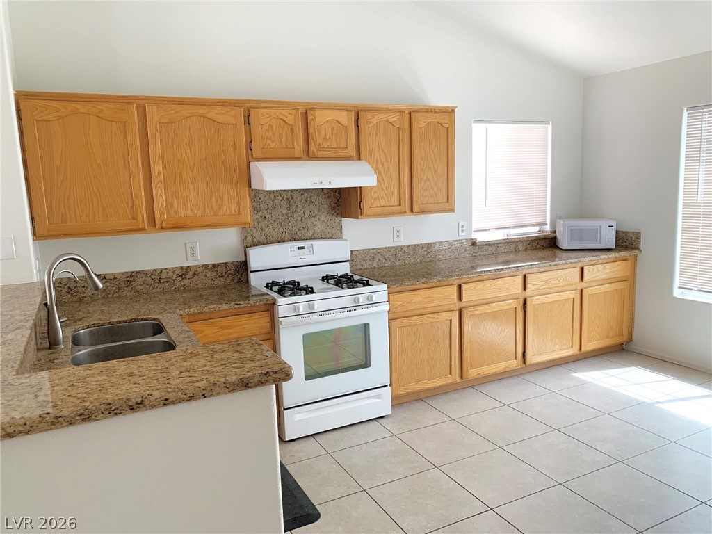 3821 Bombastic Court Las Vegas, NV 89147 - Photo 8 of 36 This spacious kitchen offers ample cabinetry, durable countertops, and abundant natural light.