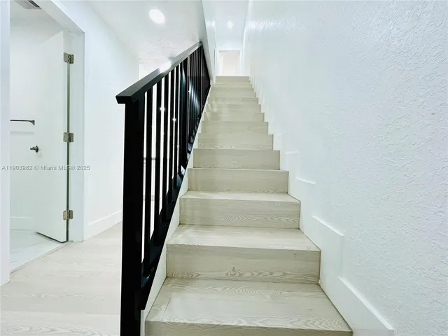 a kitchen with a refrigerator and a sink