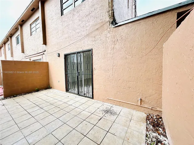 a view of a house with a yard and sitting area