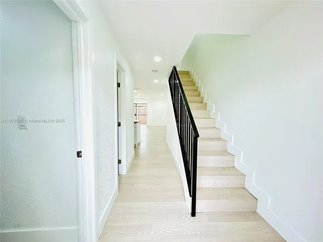 a view of a hallway with a white door