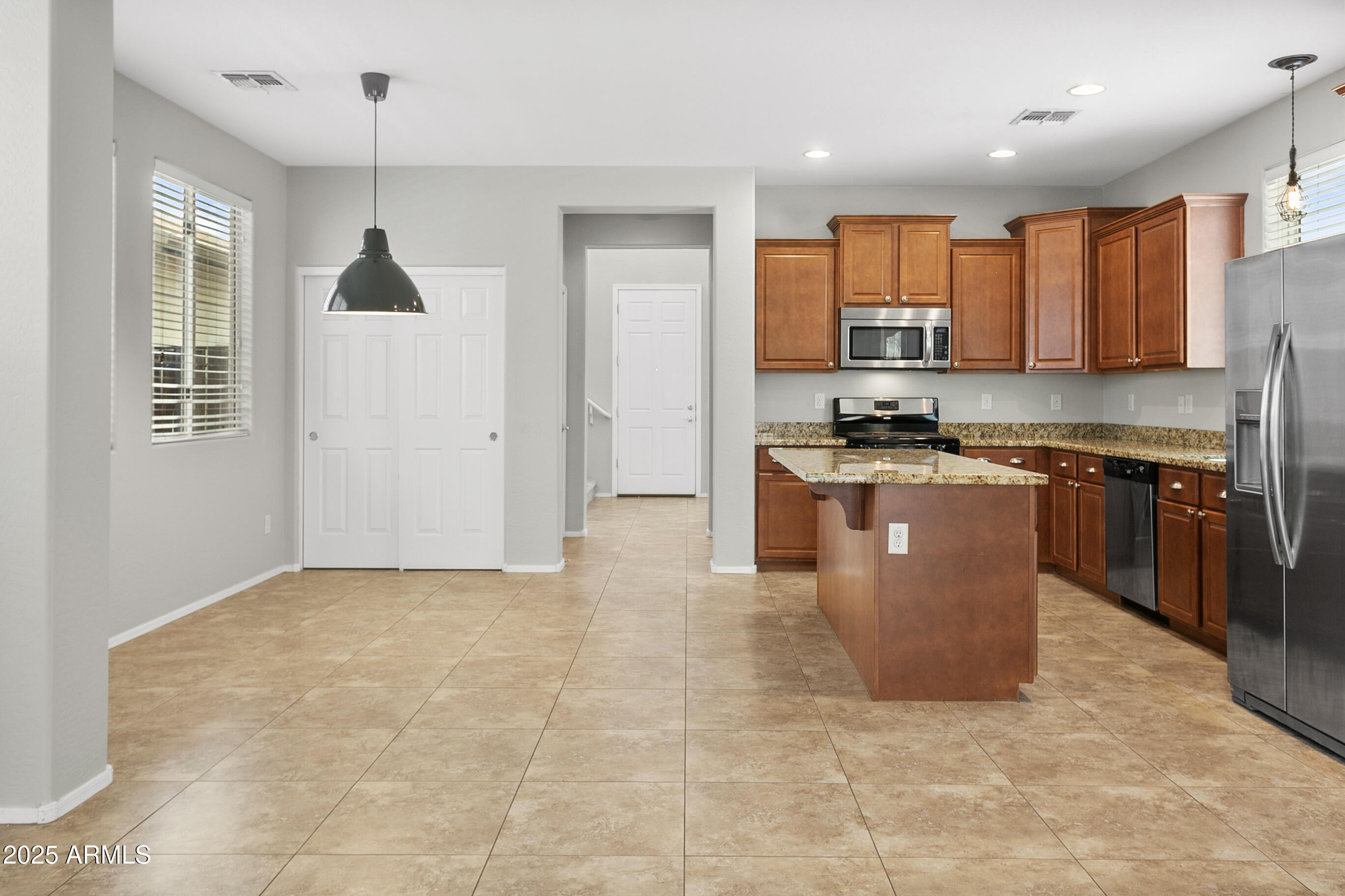 9124 South Roberts Road Tempe, AZ 85284 - Photo 14 of 27 a kitchen with stainless steel appliances granite countertop a stove top oven a sink a counter top space cabinets and a window