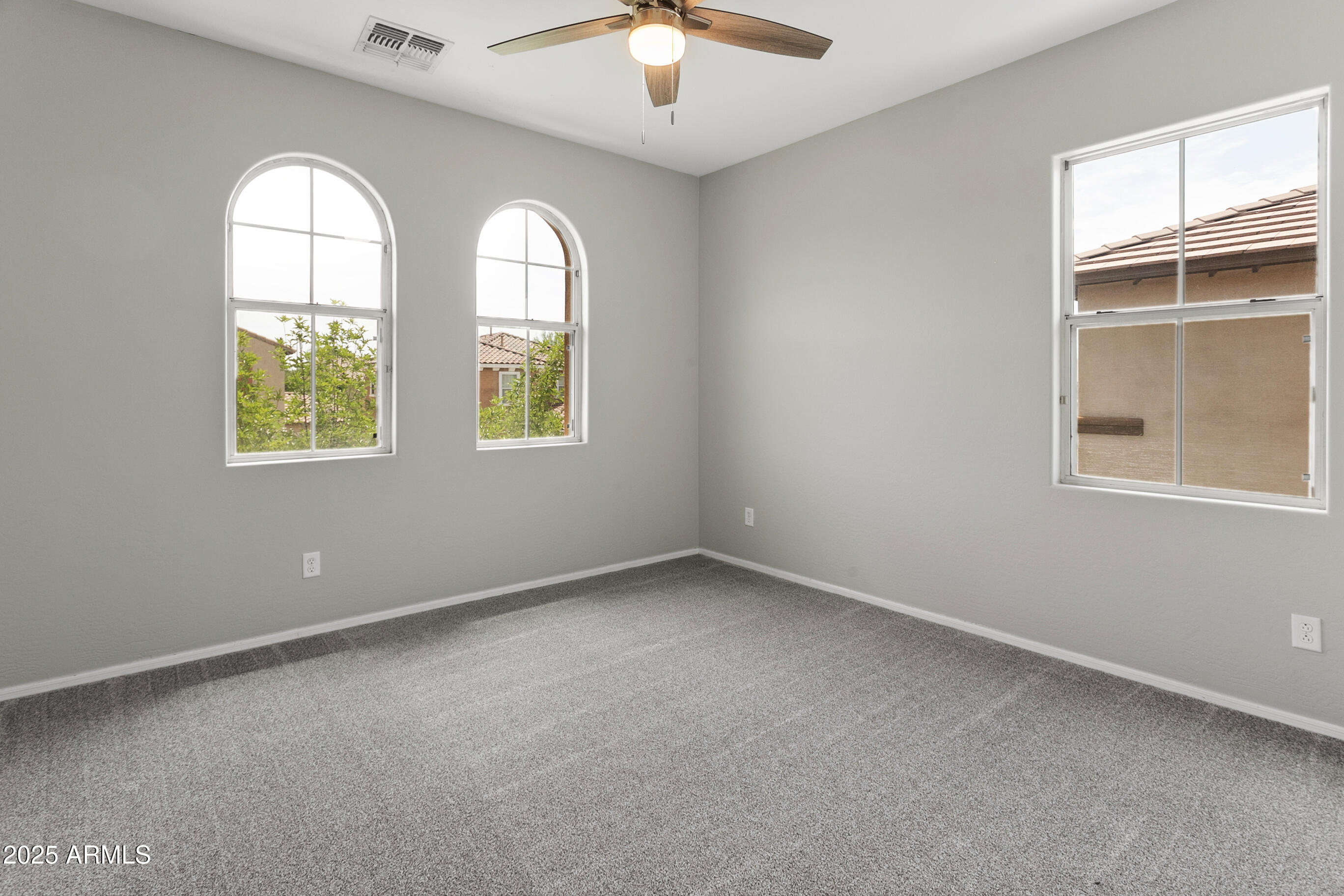 9124 South Roberts Road Tempe, AZ 85284 - Photo 16 of 27 an empty room with windows and chandelier fan