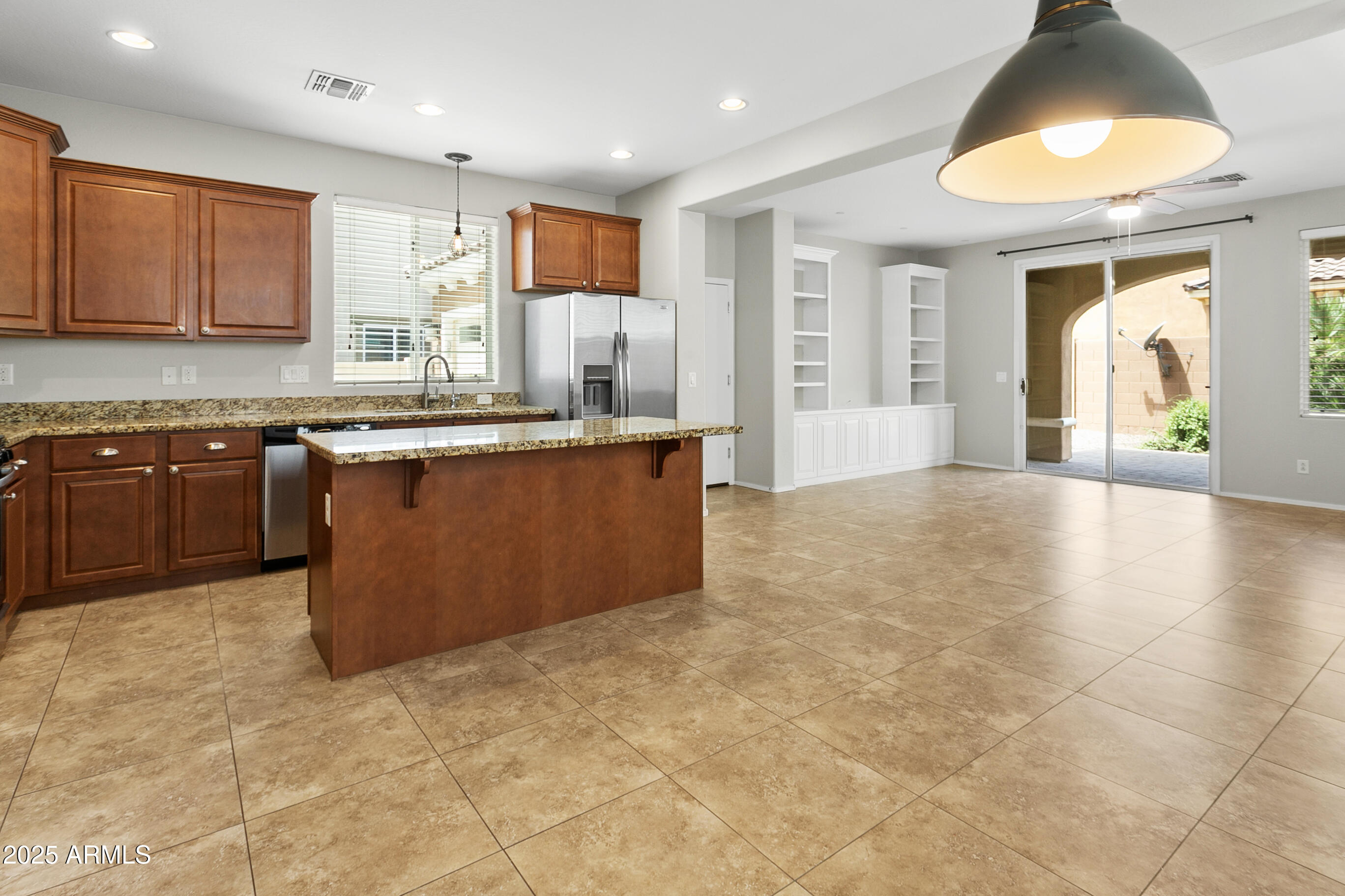 9124 South Roberts Road Tempe, AZ 85284 - Photo 7 of 27 a large kitchen with kitchen island granite countertop a sink and a stove top oven