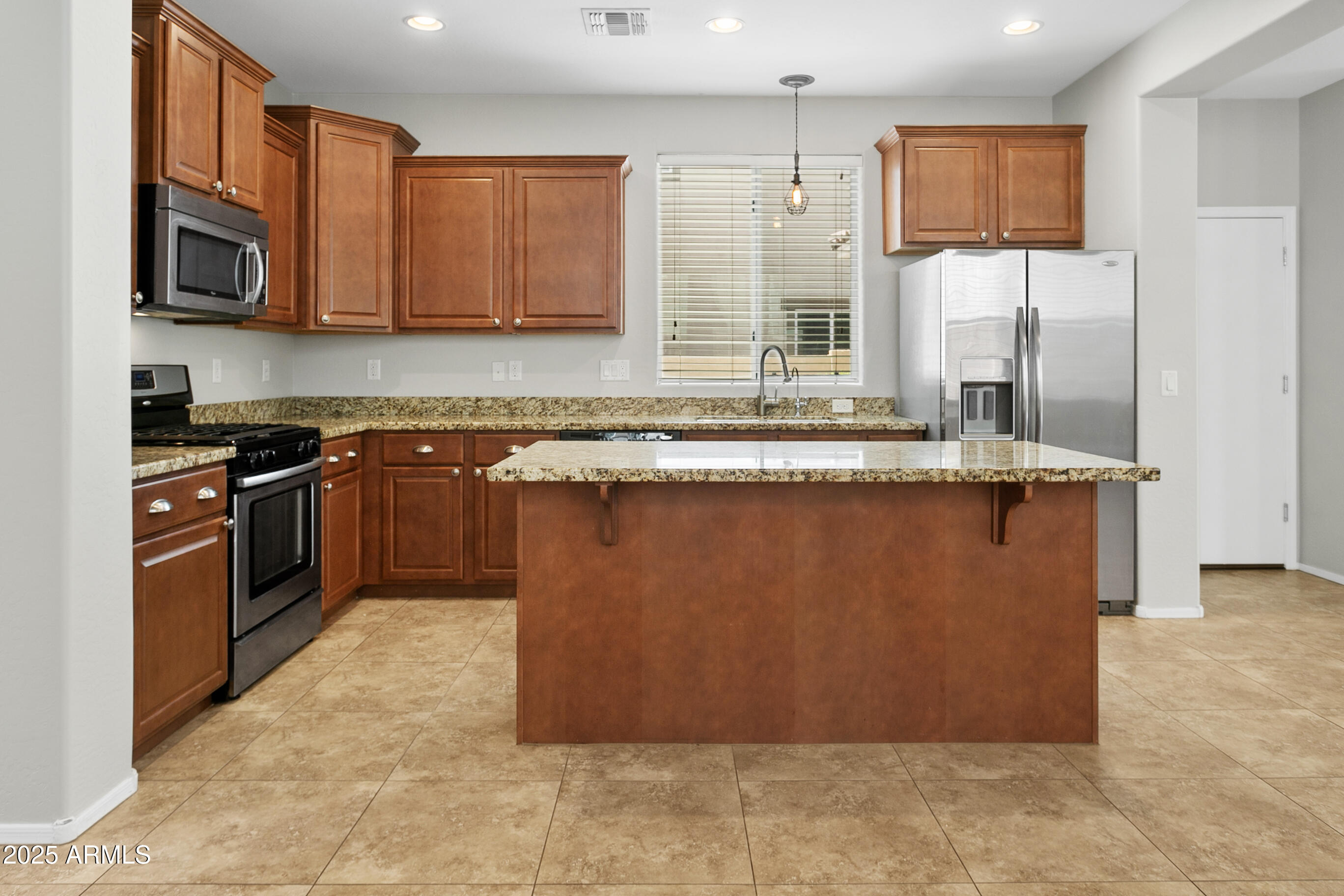 9124 South Roberts Road Tempe, AZ 85284 - Photo 8 of 27 a kitchen with stainless steel appliances granite countertop a stove a sink and a microwave