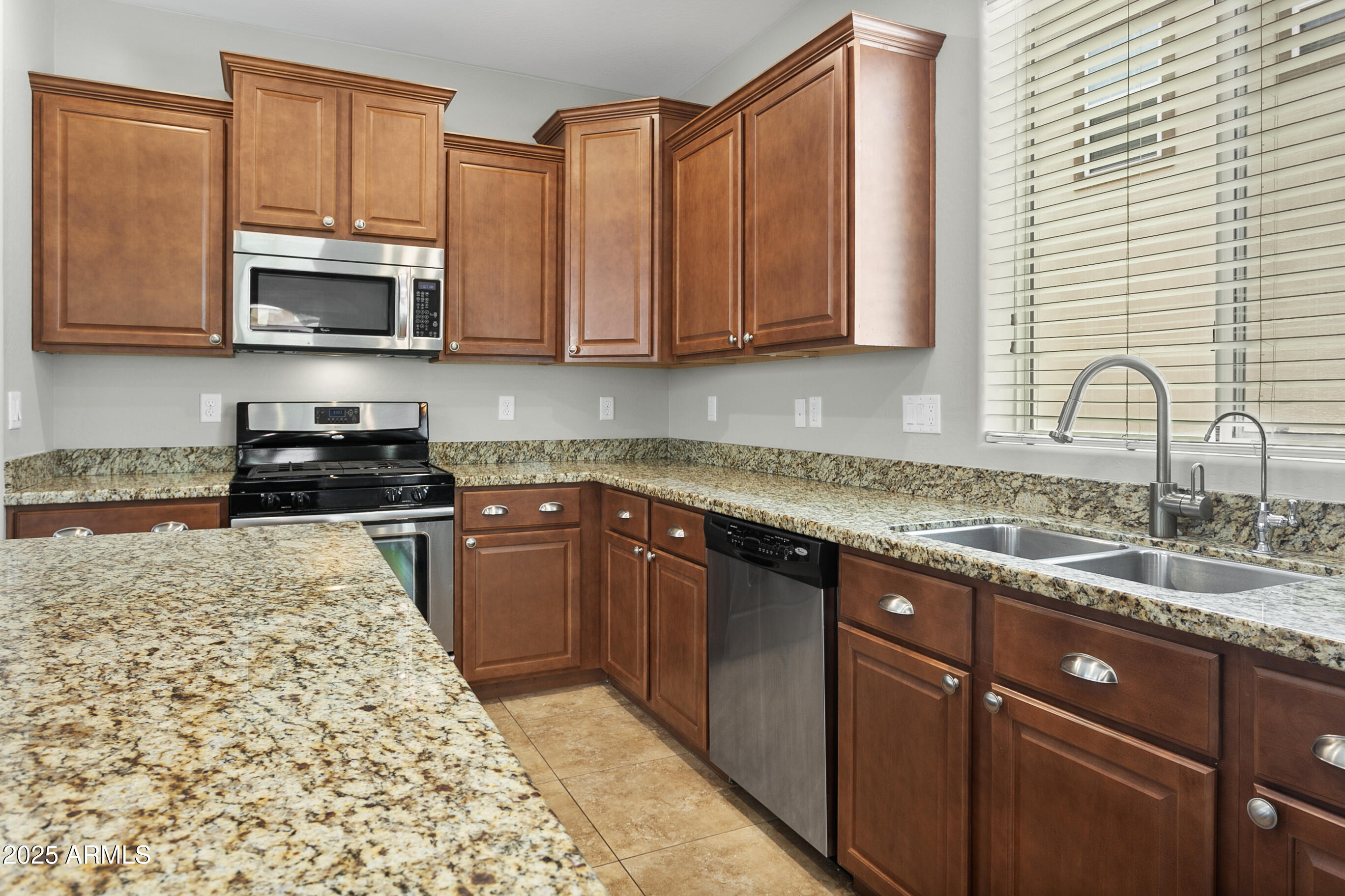9124 South Roberts Road Tempe, AZ 85284 - Photo 10 of 27 a kitchen with stainless steel appliances granite countertop a sink stove and microwave