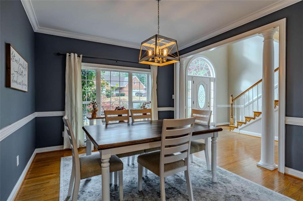 26 Saddlebrook Drive Rome, GA 30161 - Photo 11 of 63 a dining room with wooden floor a chandelier a wooden table and chairs