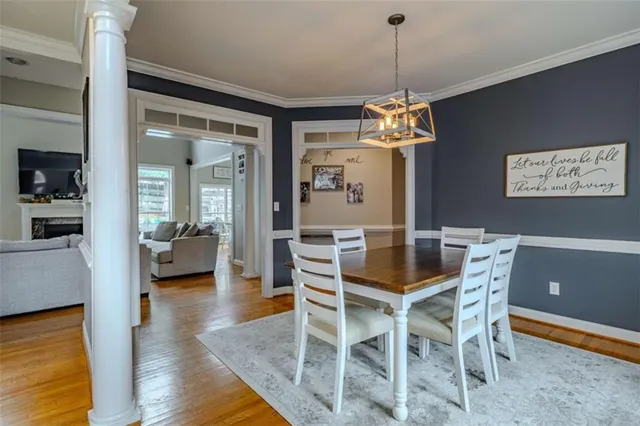 a living room with fireplace furniture and a wooden floor