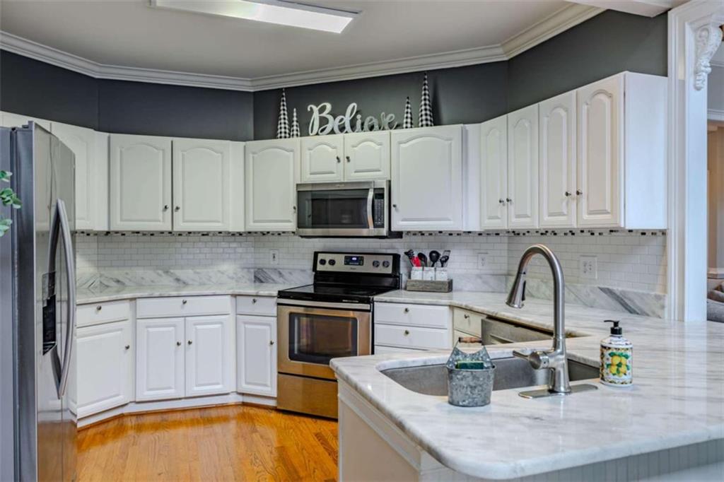 26 Saddlebrook Drive Rome, GA 30161 - Photo 20 of 63 a kitchen with granite countertop a sink stainless steel appliances and cabinets