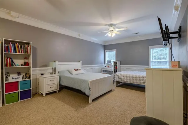 a bedroom with a bed and a painting on the wall