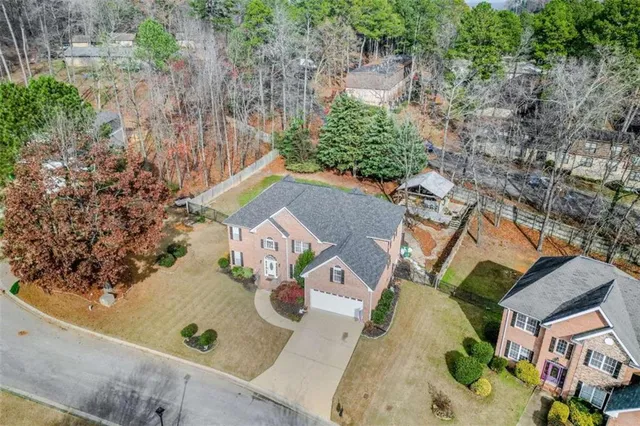 an aerial view of residential house with outdoor space and trees
