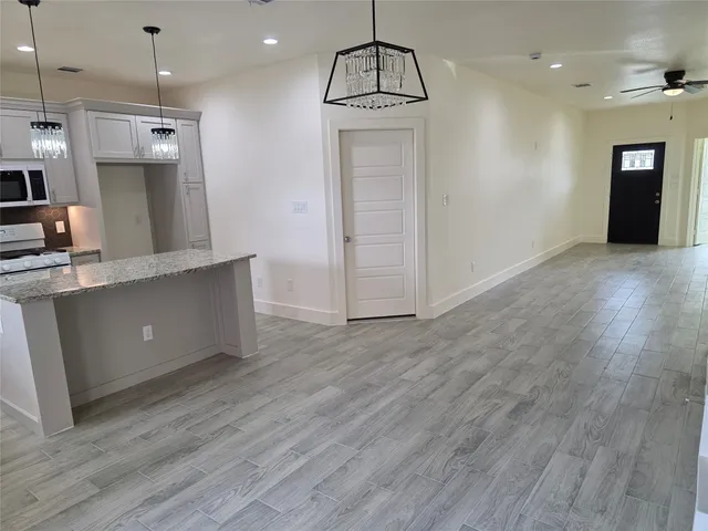 a view of a kitchen with a sink and a refrigerator